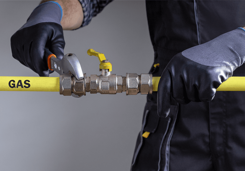 Technician adjusting yellow gas pipe