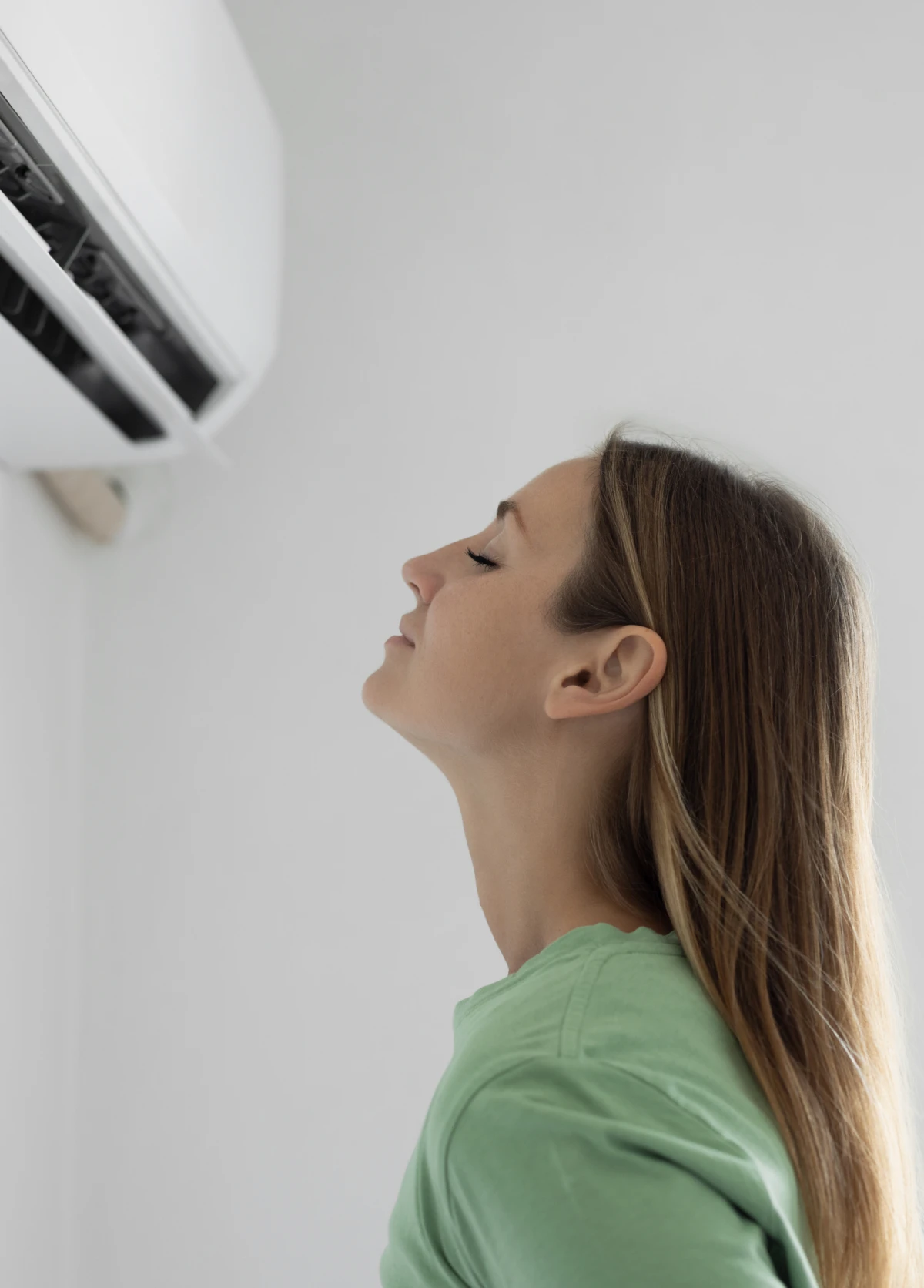 Woman enjoying air conditioning breeze