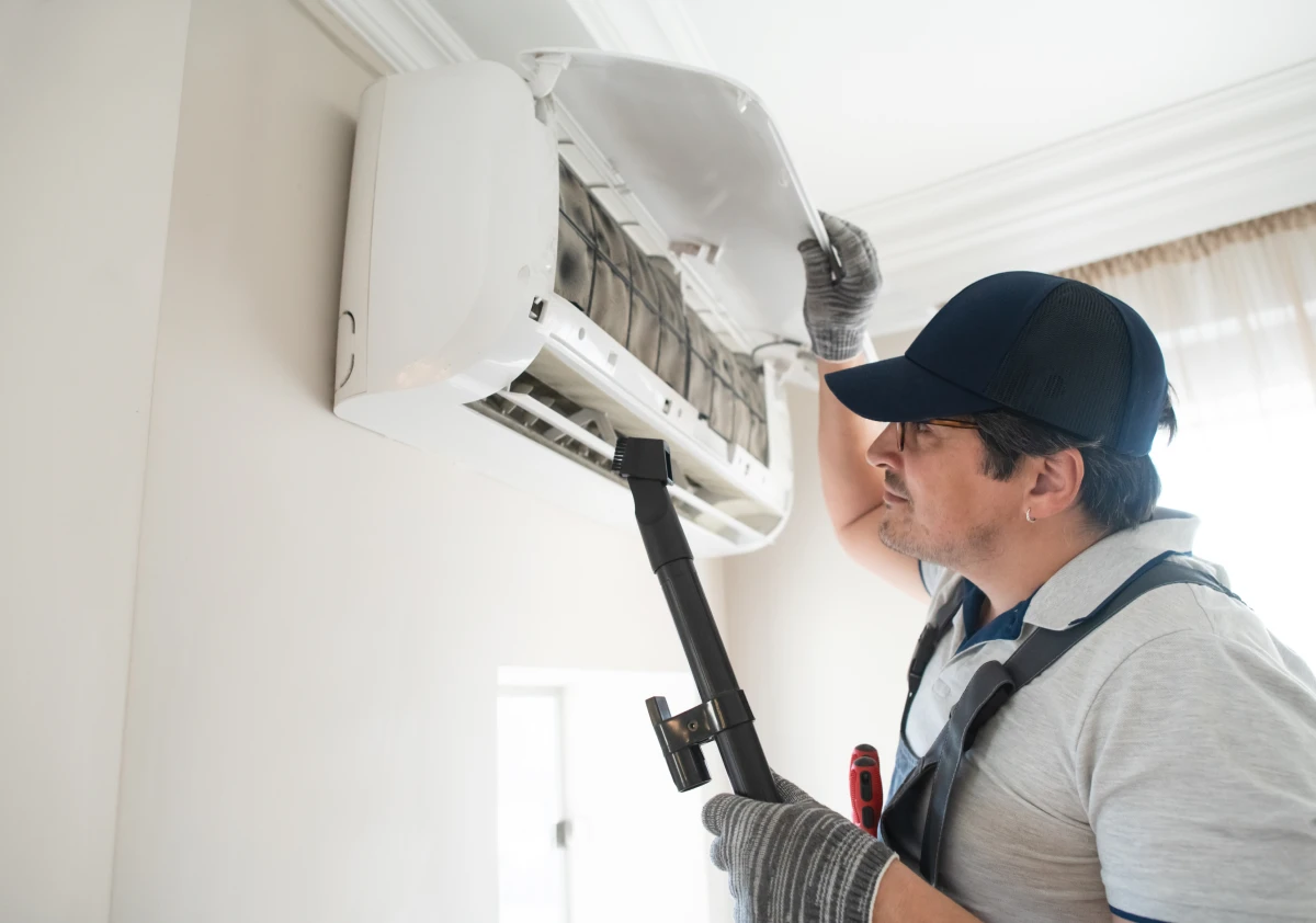 Man servicing air conditioner