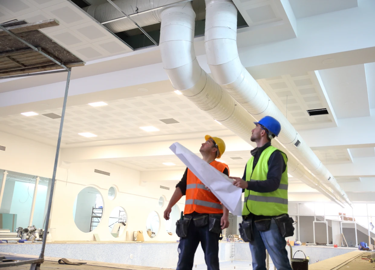 Workers assessing indoor construction project