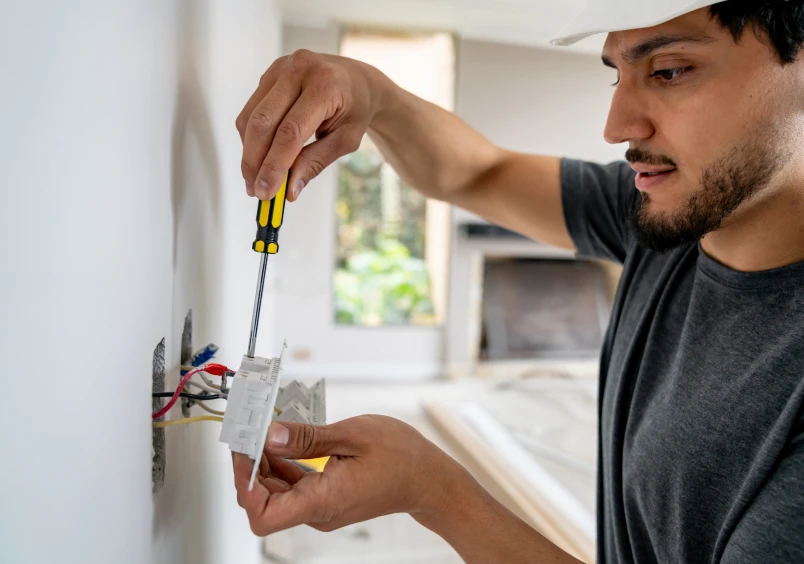 Handyman using screwdriver on socket