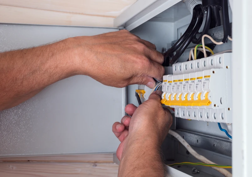 Electrician working on circuit breaker panel